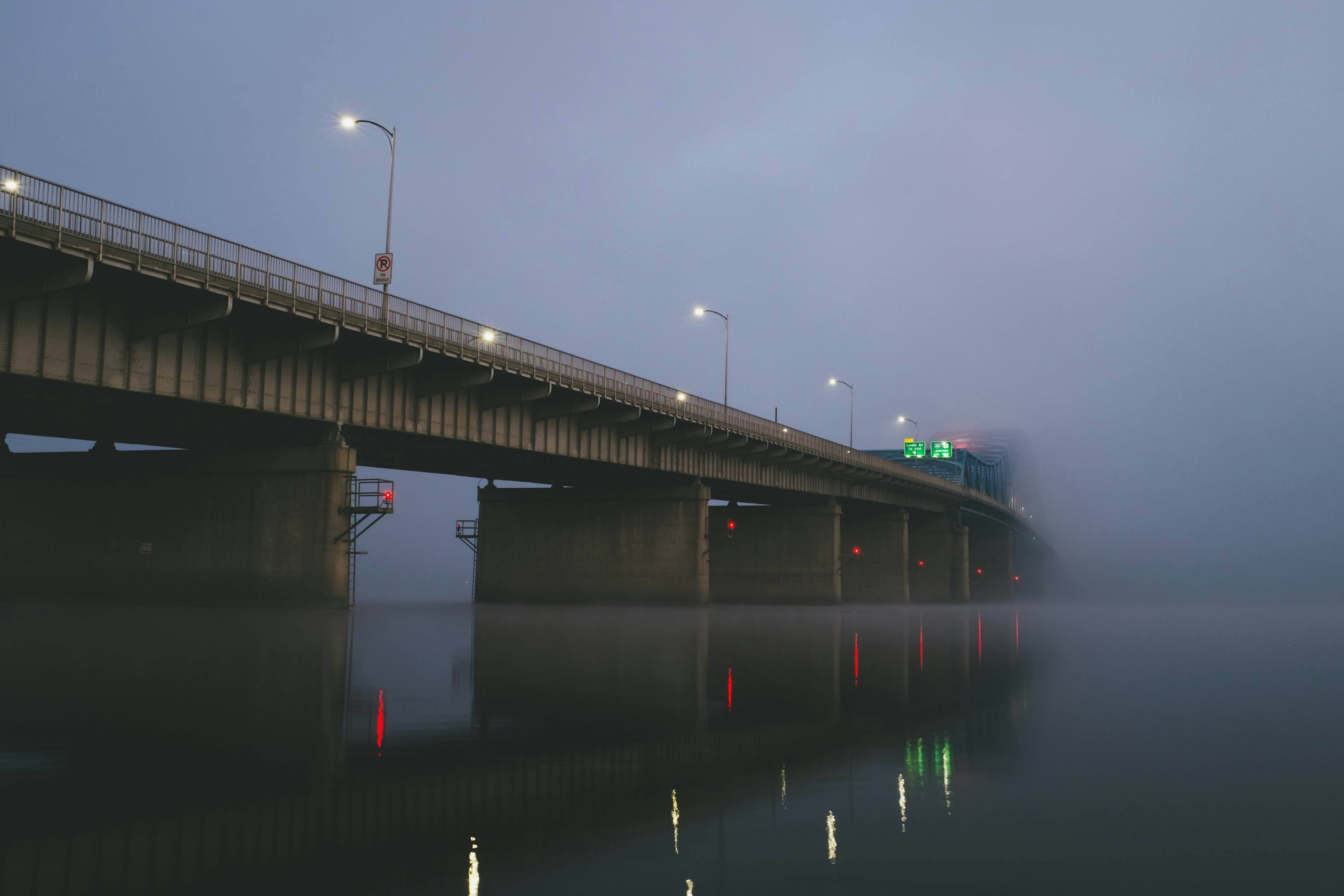 bridge covered with thick fog during daytime